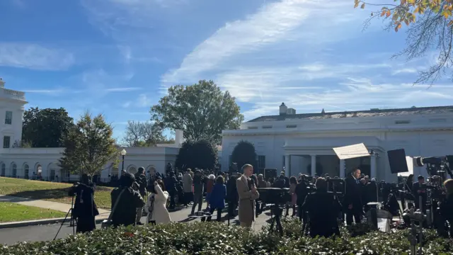 Reporters outside the White House