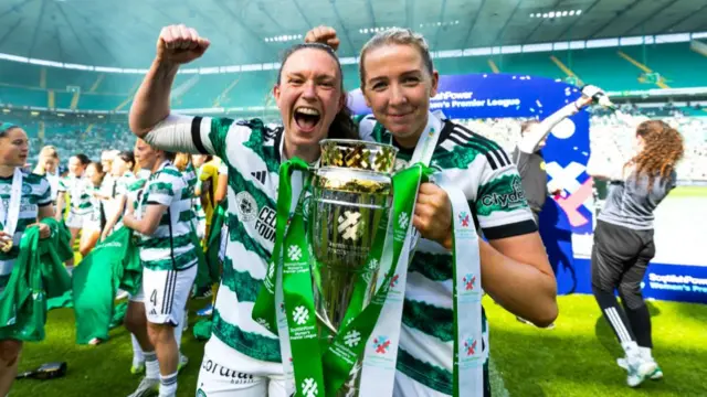 Celtic's Kelly Clark and Chloe Craig celebrates with the SWPL Trophy during a Scottish Power Women's Premier League match between Celtic and Hibernian at Celtic Park