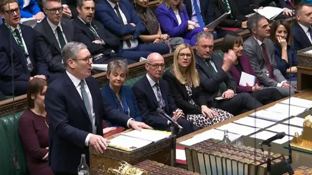 Keir Starmer at the dispatch box answering questions at PMQs. Behind him on the green benches of the Commons are, left to right, Rachel Reeves, Yvette Cooper, Pat McFadden and Ellie Reeves