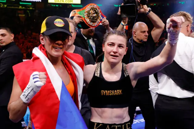 Amanda Serrano and Katie Taylor hold up their fists