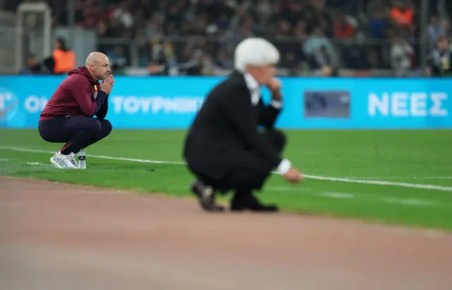 Carsely and Jovanovic kneel in their respective technical area