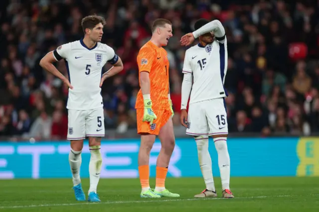 Jordan Pickford, John Stones and Levi Colwill of England look dejected