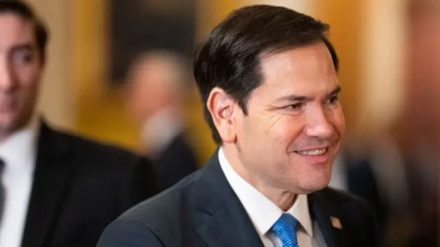 Marco Rubio wearing a suit and blue tie