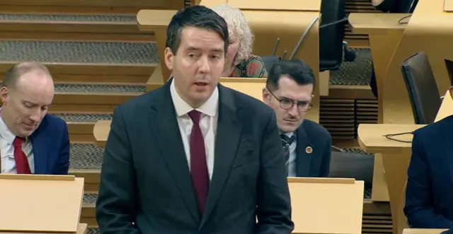 Neil Bibby standing in the chamber at Holyrood