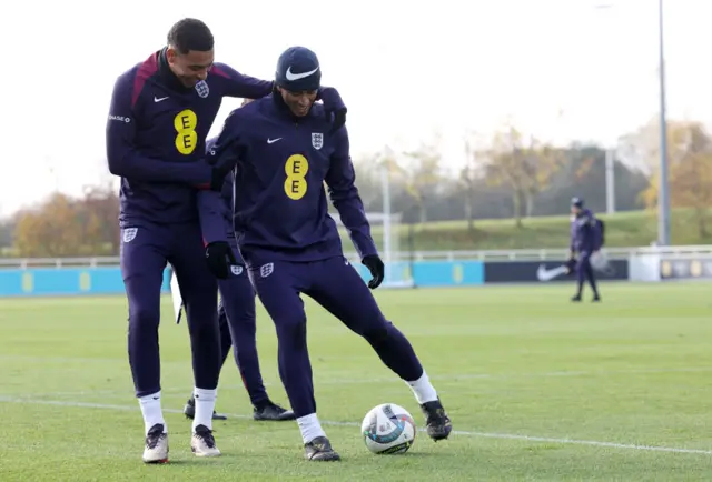 Morgan Rogers and Jude Bellingham of England interact during a training session