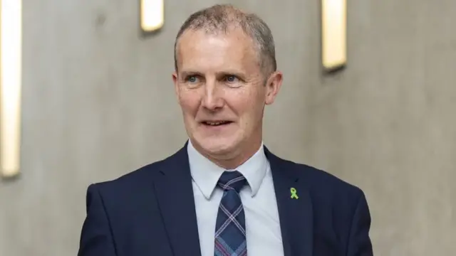 Former Health Secretary Michael Matheson stands in Holyrood