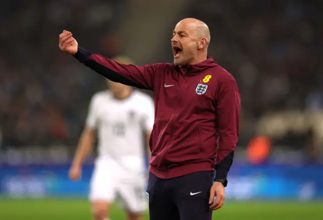 Carsley shouts and waves at his team from the sideline