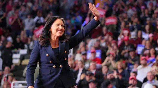 Tulsi Gabbard on stage waving to supporters