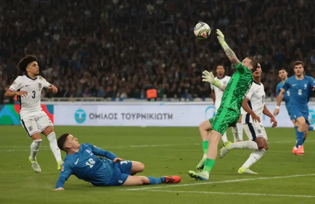 Pickford reaches up to palm a shot away from goal