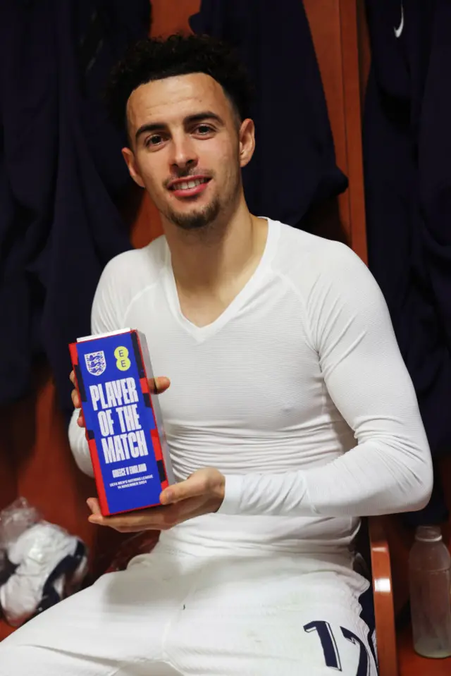 Curtis Jones in the England dressing room with his player of the match award