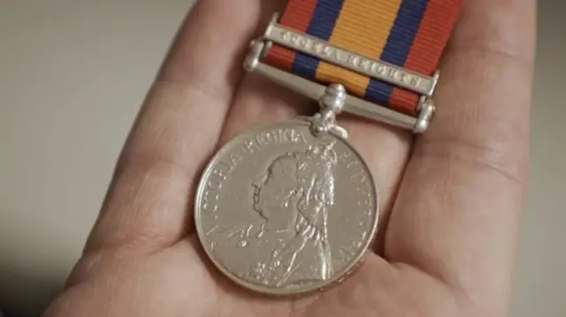 A close up of Paddy's Grandfather's war medal
