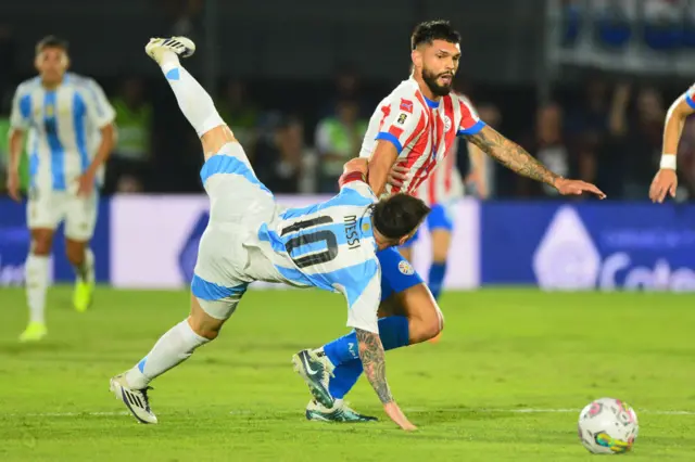 Argentina forward Lionel Messi and Paraguay defender Omar Alderete fight for the ball
