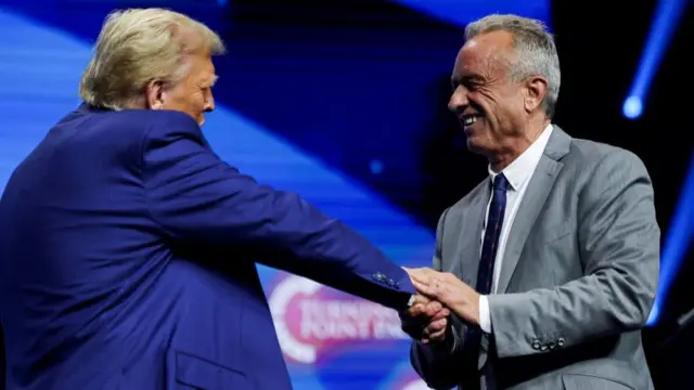 Donald Trump shaking hands with Robert F Kennedy Jr at a campaign event in October