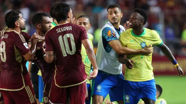 Vinicius Junior of Brazil argues with players of Venezuela