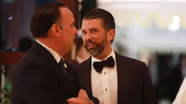 Donald Trump Jr speaks with another man