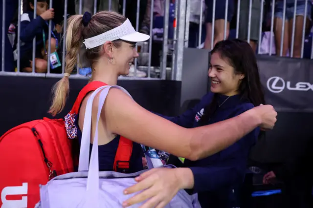 Katie Boulter of Great Britain celebrates victory against Laura Siegemund of Germany with team mate Emma Raducanu
