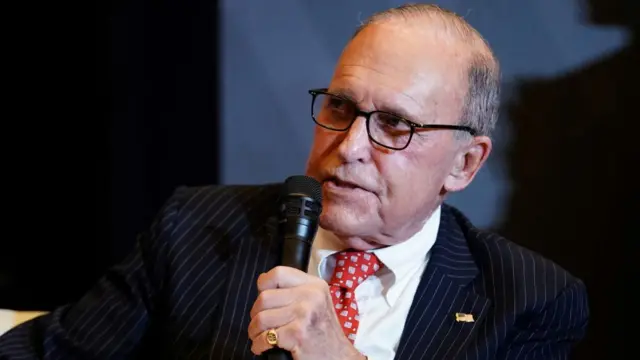 Kudlow speaks into a microphone