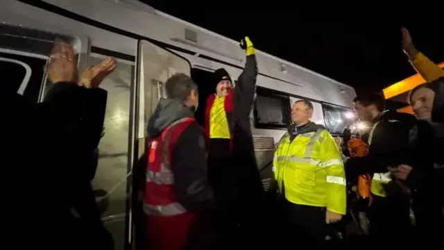 Paddy looking triumphant - fist in the air - in front of a crowd of supporters after he'd finished day 4