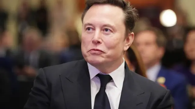 Elon Musk in a suit