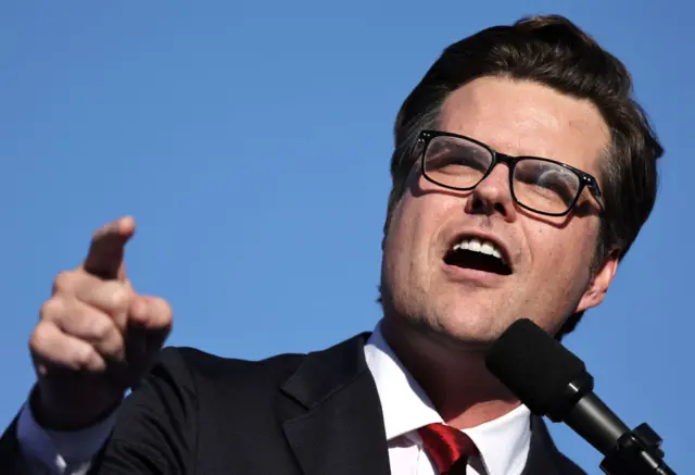 Matt Gaetz speaking into a microphone, gesturing with his right hand