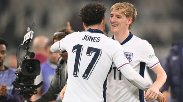 Curtis Jones and Anthony Gordon of England embrace after the team's victory