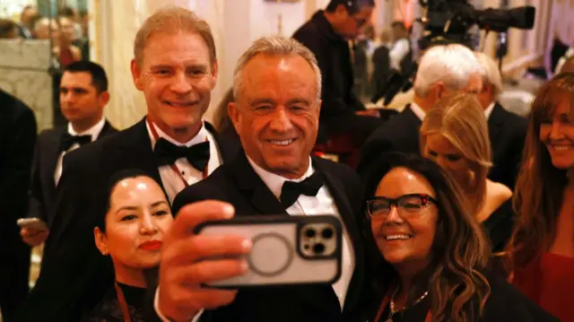 Robert F Kennedy Jr takes a selfie with other gala attendees