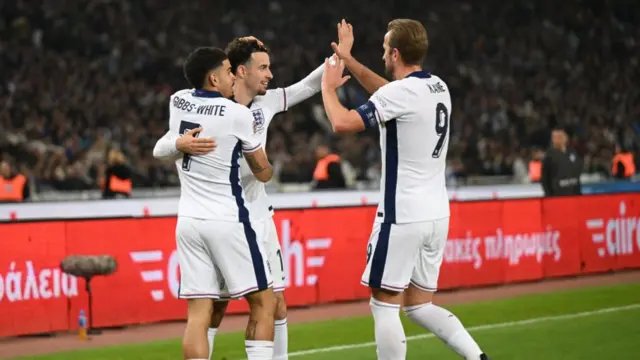 Curtis Jones celebrates scoring his team's third goal with teammates Morgan Gibbs-White and Harry Kane