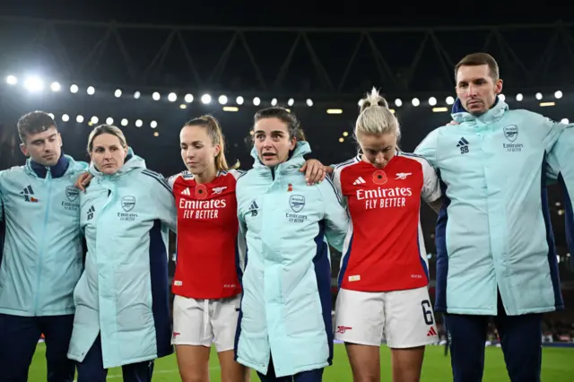 Renee Slegers speaks to Arsenal players and staff after a game