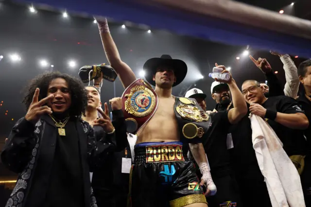 Gilberto Ramirez celebrates with his world titles