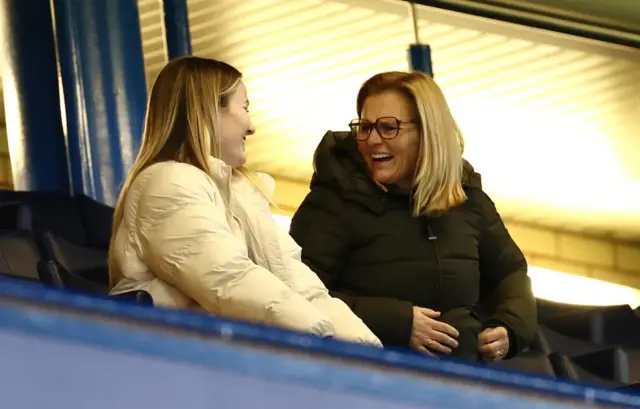 Hemp and Wiegman share a laugh in the stands