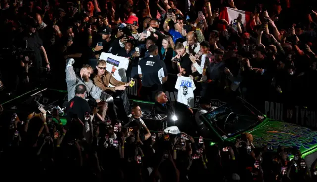 Jake Paul enters the ring in a green truck