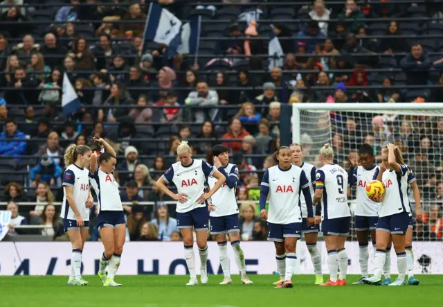 Tottenham players react to Arsenal's second goal