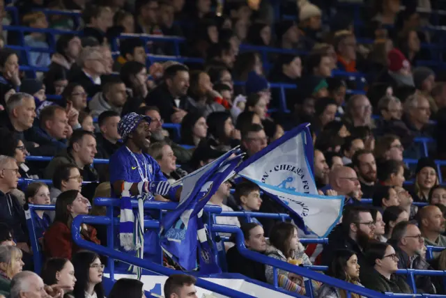 Chelsea fans wave flags in the stand