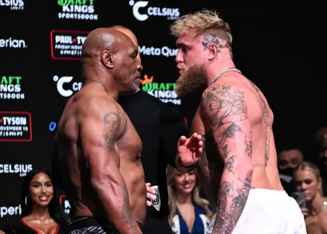 Mike Tyson and Jake Paul stand face to face