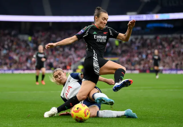 Foord jumps to evade a slide tackle