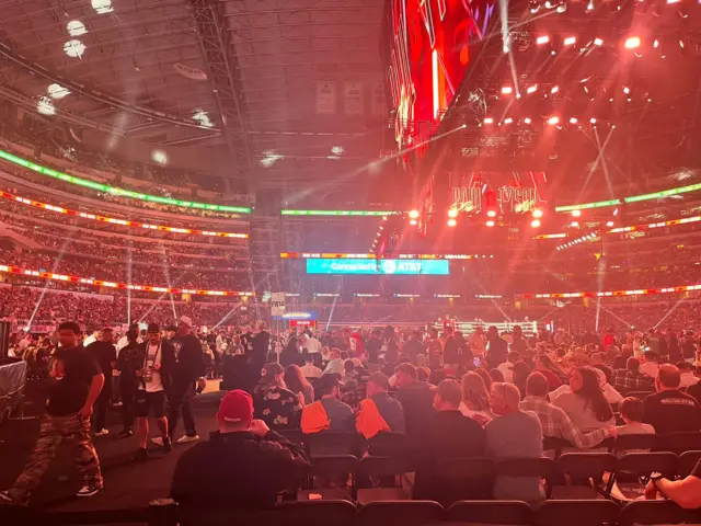 A view of the AT&T Arena with fans in their seats and bright lights