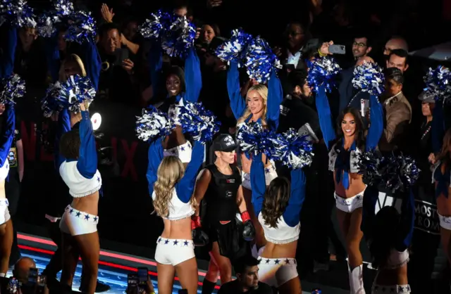 Katie Taylor makes her ringwalk flanked by the Dallas Cowboy cheerleaders