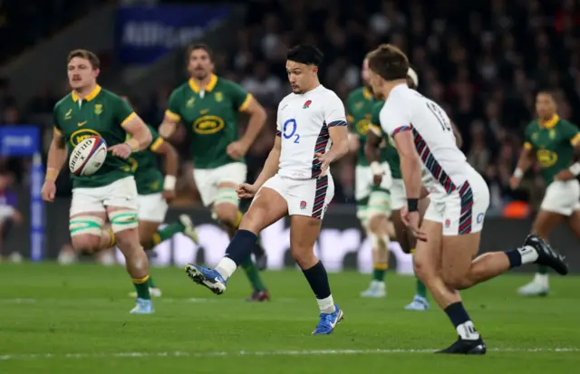 Smith kicking the ball mid-play