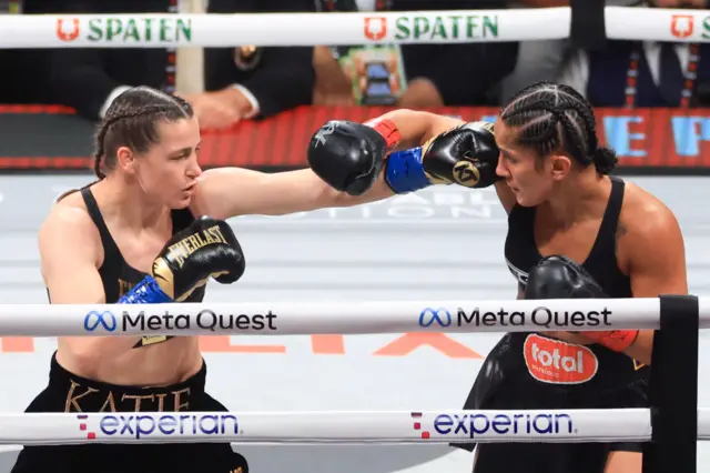 Katie Taylor and Amanda Serrano throw punches