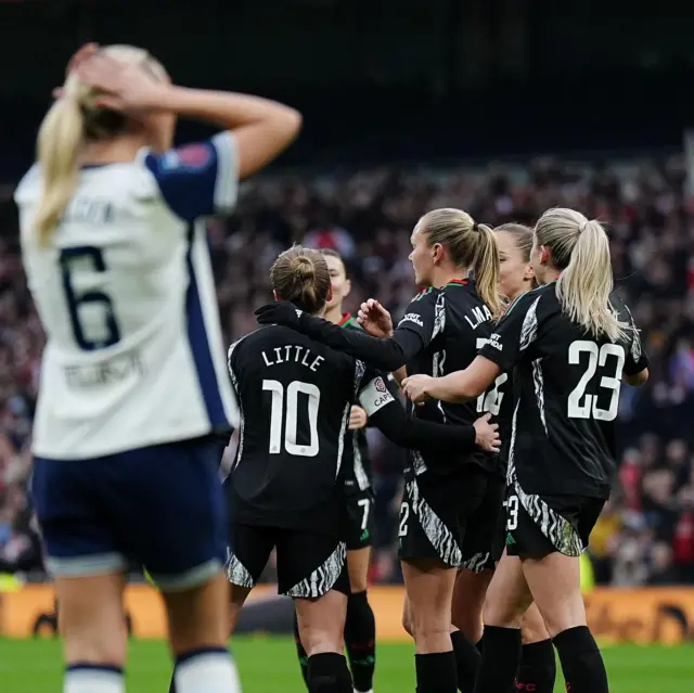 Arsenal celebrate as Tottenham players look on