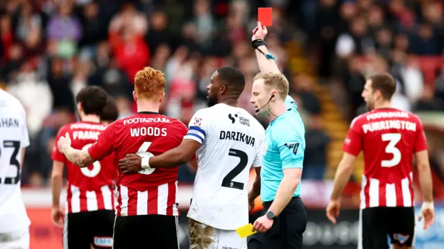 Ryan Woods is shown a red card