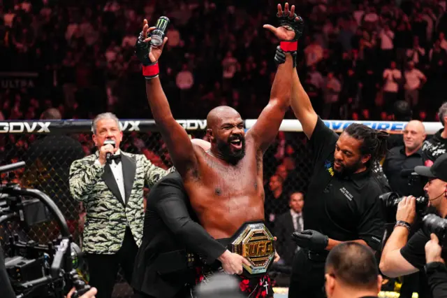 Jon Jones holds up his arms