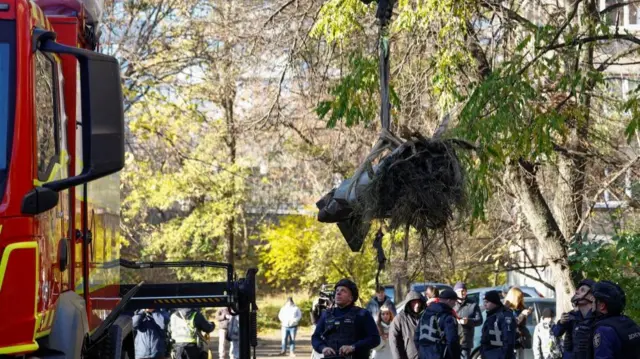 A crane removing a piece of a Russian missile from a neighbourhood in Kyiv