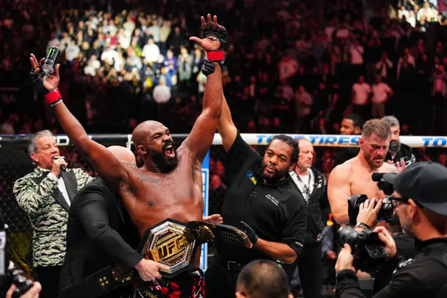 Jon Jones celebrates with UFC title