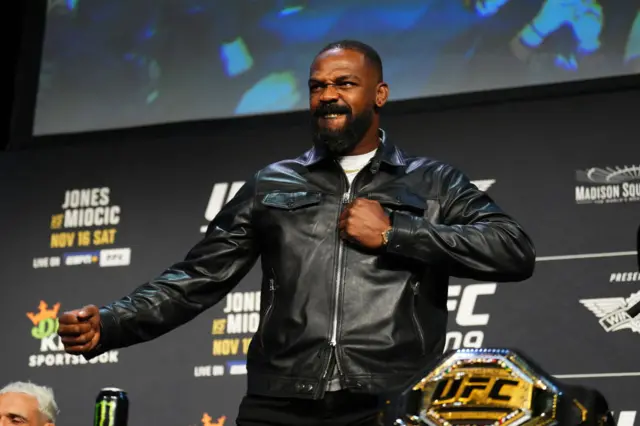 Jon Jones holds out his arm