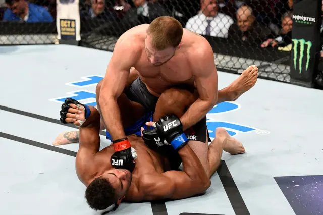 Stipe Miocic throws a punch at Alastair Overeem