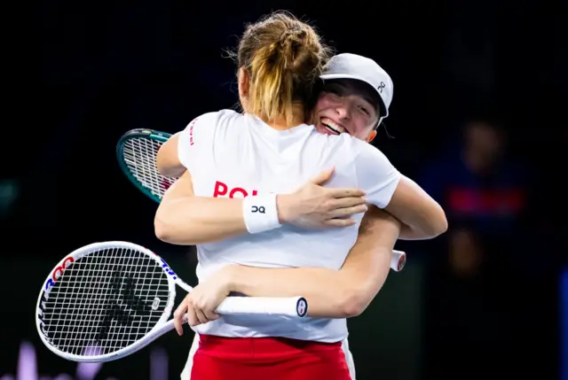 Iga Swiatek of Poland and Katarzyna Kawa of Poland react to defeating Czechia in the Billie Jean King Cup Finals