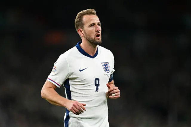 Harry Kane of England looks on