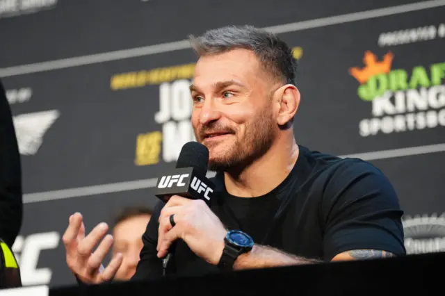 Stipe Miocic speaks into a microphone