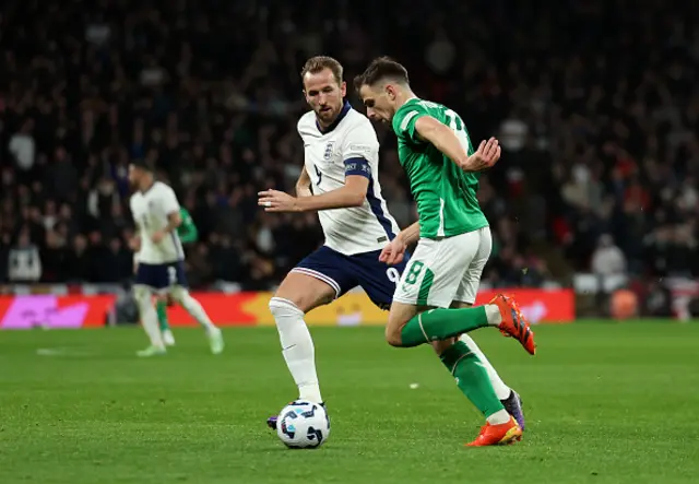 Harry Kane of England battles for possession with Jayson Molumby